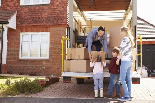 Moving van service with furniture and boxes being loaded for transport