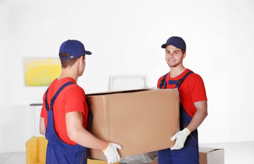 Careful unpacking of household items in a Brompton property