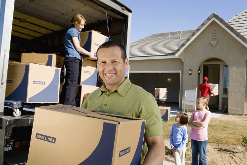 Local removals crew unloading household items at a Brompton property