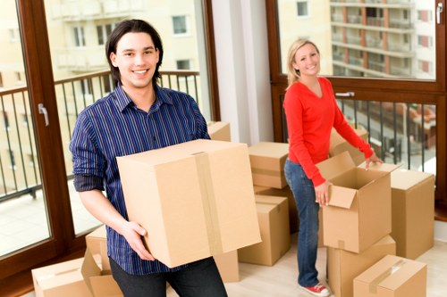 Professional movers loading furniture and boxes for a Brompton relocation